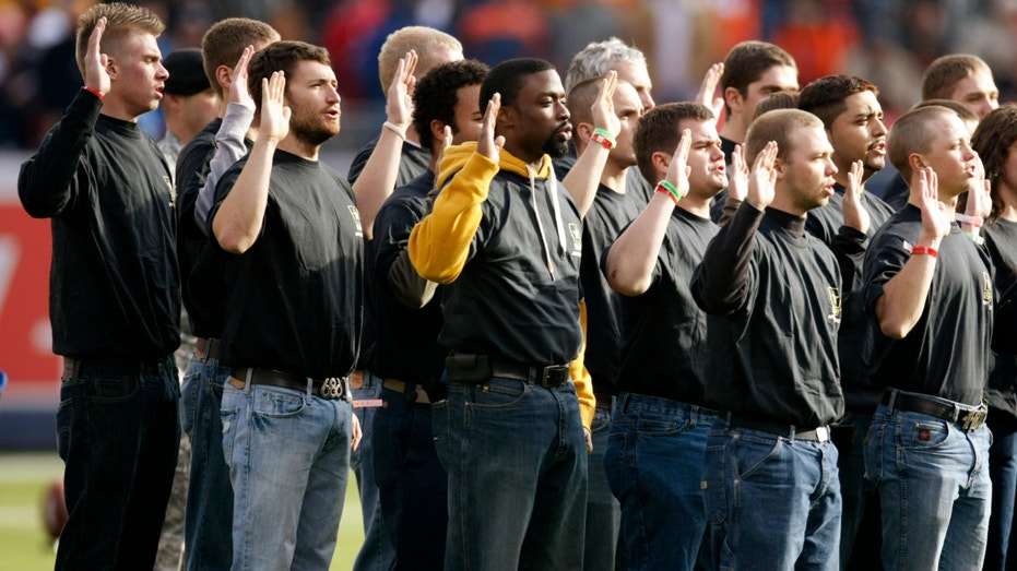 U.S. Army recruits take their service oath in an enlistment ceremony before the Denver Broncos against Kansas City Chiefs NFL football game in Denver on Nov. 14, 2010.