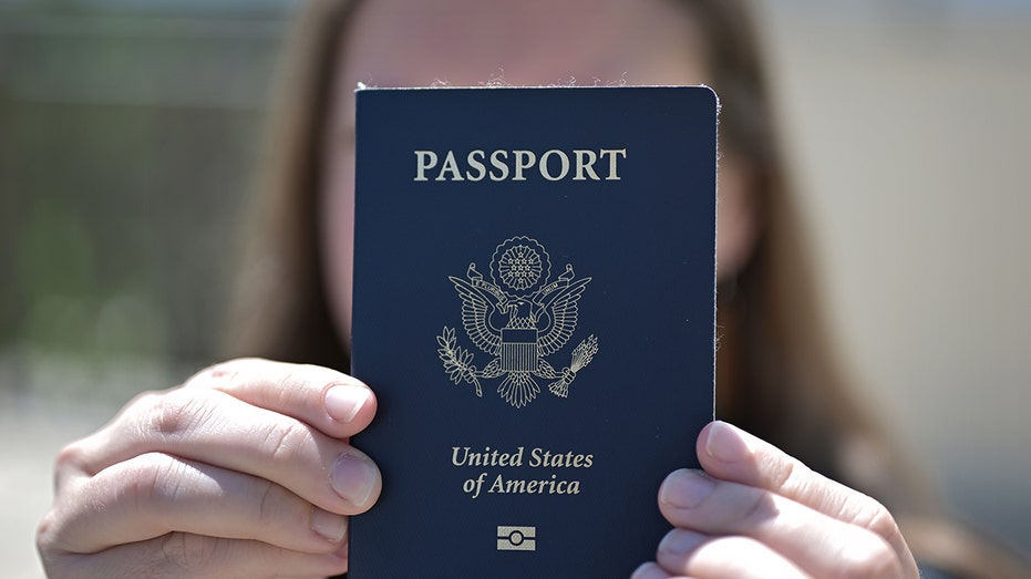 Woman holds up passport
