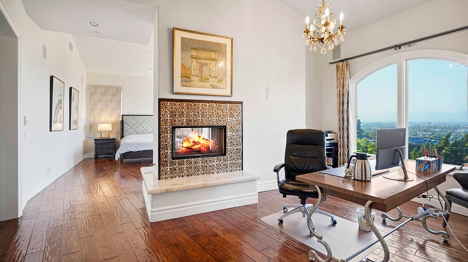On the other side of the double-sided fireplace is the dedicated office.