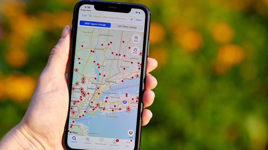 Zillow app on phone in someone's hand