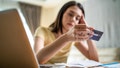 A stressed young woman looks frustrated at paperwork and bills while thinking of money debt, budget loss and bankruptcy at home. - Fox News