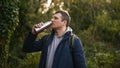 A man is drinking out of a stainless steal water bottle. - Fox News