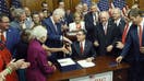 WASHINGTON, DC - JULY 03: U.S. Speaker of the House Mike Johnson (R-LA) shakes hands with House Majority Whip Tom Emmer (R-MN) and House Republican Conference Chair Rep. Lisa McClain (R-MI) alongside fellow House Republicans during an enrollment ceremony for H.R. 1, the One, Big, Beautiful Bill Act at the U.S. Capitol on July 03, 2025 in Washington, DC. The House passed the sweeping tax and spending bill after winning over fiscal hawks and moderate Republicans. The bill makes permanent President Donald Trump’s 2017 tax cuts, increase spending on defense and immigration enforcement and temporarily cut taxes on tips, while at the same time cutting funding for Medicaid, food assistance for the poor, clean energy and raises the nation’s debit limit by $5 trillion. - Fox Business News