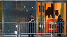 Police officers stand next to the glass window with a bullet hole near the scene of a deadly mass shooting in Manhattan, New York City, U.S. July 29, 2025. - Fox Business News