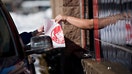 An employee hands a customer their order at the drive-thru window of a Wendy's Co. restaurant in Peoria, Illinois, U.S., on Monday, Feb. 2, 2015.  - Fox Business News