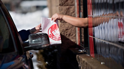 An employee hands a customer their order at the drive-thru window of a Wendy's Co. restaurant in Peoria, Illinois, U.S., on Monday, Feb. 2, 2015.  - Fox Business News