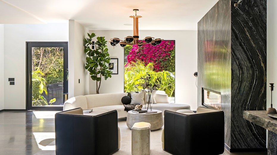 The entryway features a sitting room with a fireplace.