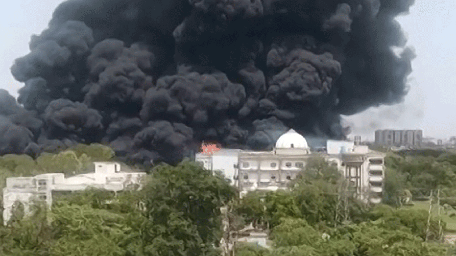huge black smoke plume rising from ground