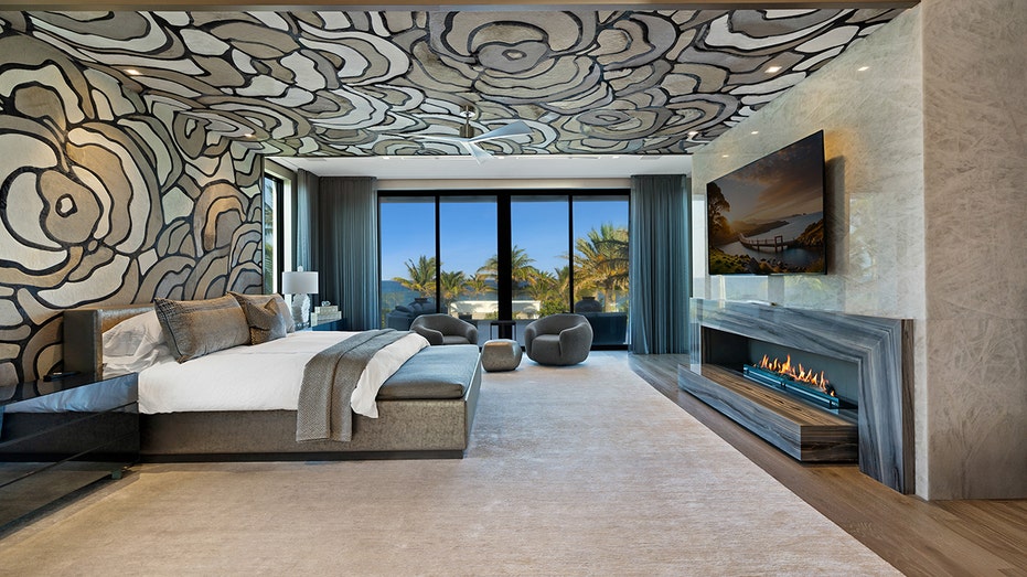 The primary bedroom features views of the ocean and a fireplace.