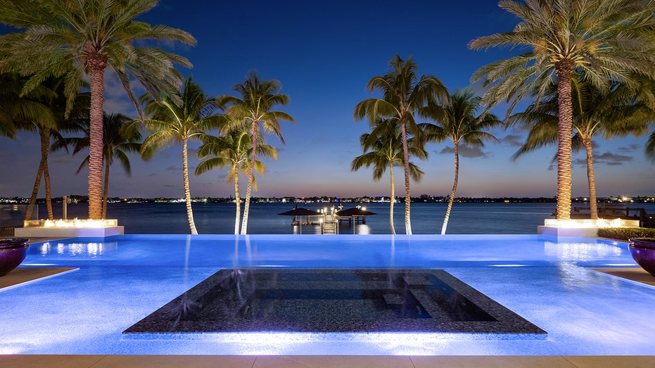 The backyard features an infinity pool.