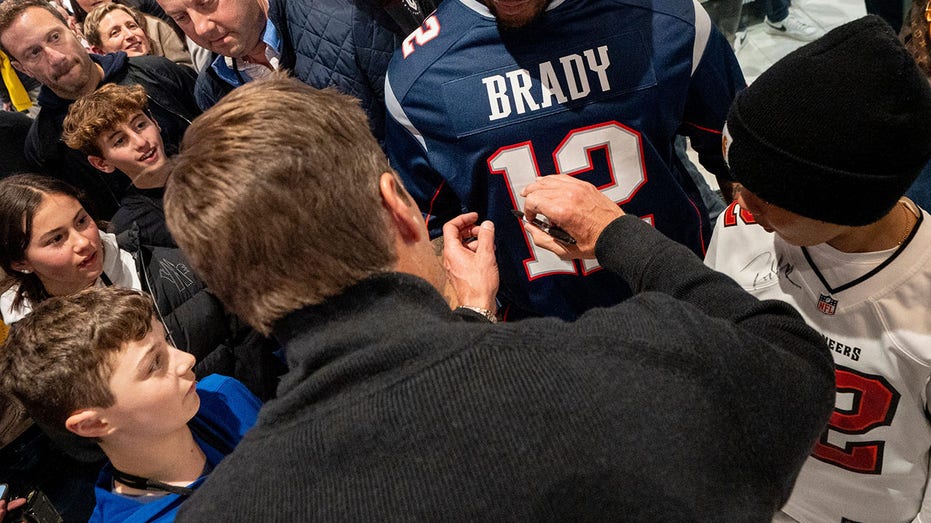 Brady signing jersey