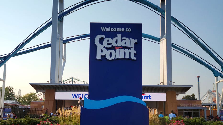 Sandusky, OH, USA - August 20, 2021: Cedar Point entrance with the gatekeeper riding on the top in the evening with sunset.