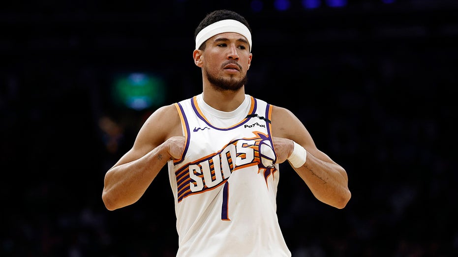 Devin Booker looks on