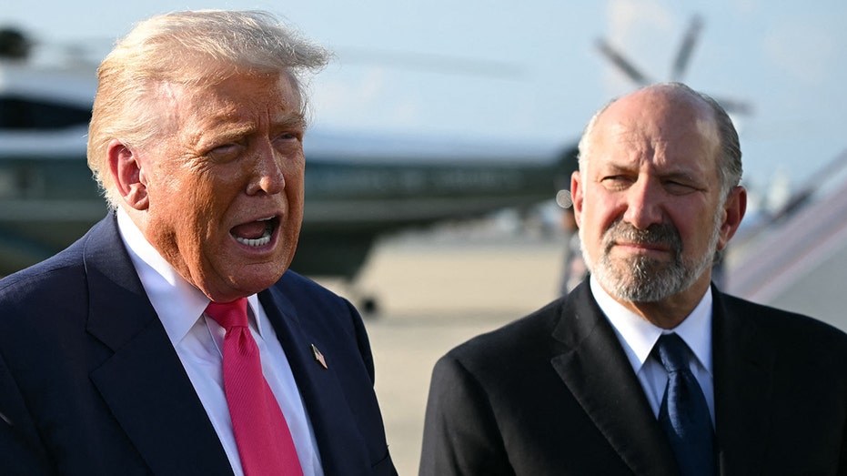 President Donald Trump and Secretary of Commerce Howard Lutnick standing side-by-side