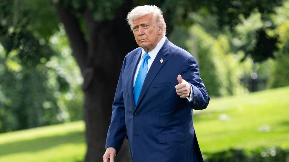 Donald Trump gives reporters a thumbs up while walking across the White House lawn
