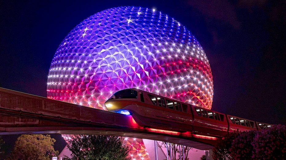 Spaceship Earth in Disney World lit up in red, white and blue
