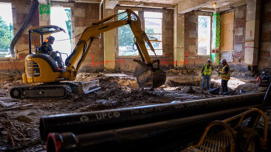 An excavator digs inside of the Federal Reserve headquarters building.