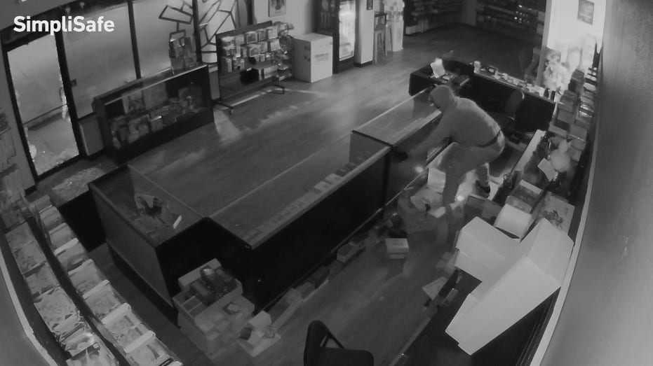 Thief stealing cards from display case