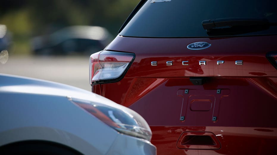A Ford Motor Escape sports utility vehicle (SUV) parked in an overflow lot in Louisville, Kentucky, U.S., on Tuesday, April 19, 2022. A shortage in automotive semiconductor chips has caused vehicle manufacturers to scale back production of automobiles. Photographer: Luke Sharrett/Bloomberg via Getty Images