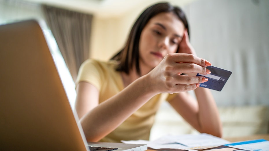 Young girl stressing over credit card