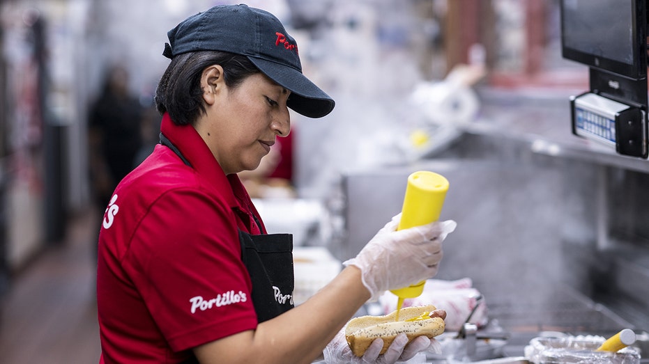 Portillon's employee makes a hot dog