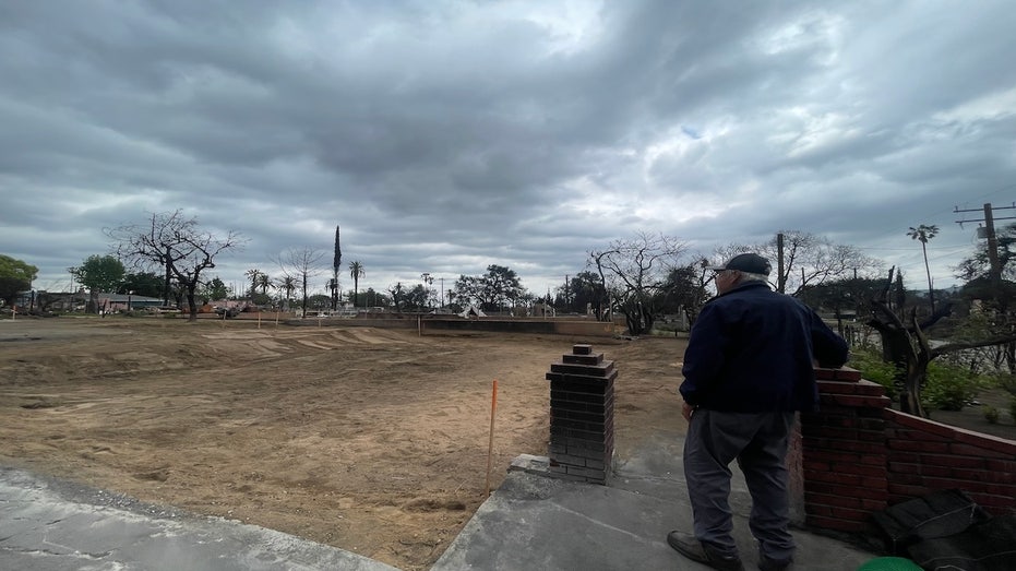 The man looked over the paved land where his house once stood.