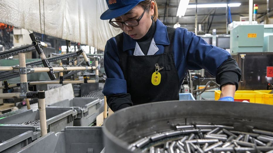 A worker in Japan works at an auto parts factory