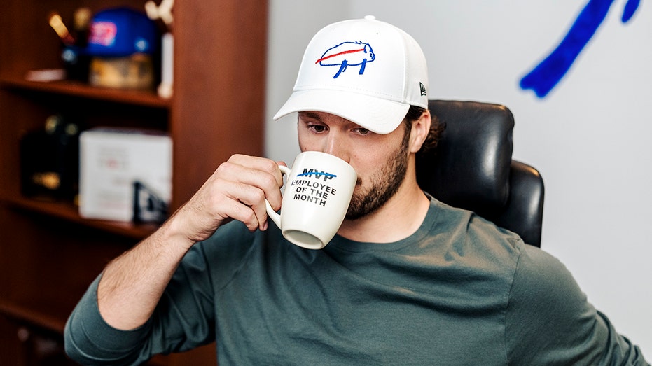 Josh Allen drinks from mug