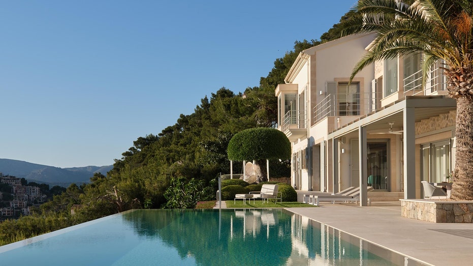 The backyard features a pool on the edge of the property.