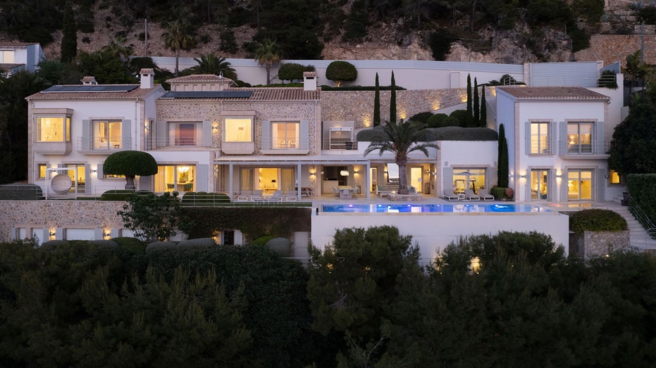 The exterior of a home with a swimming pool.