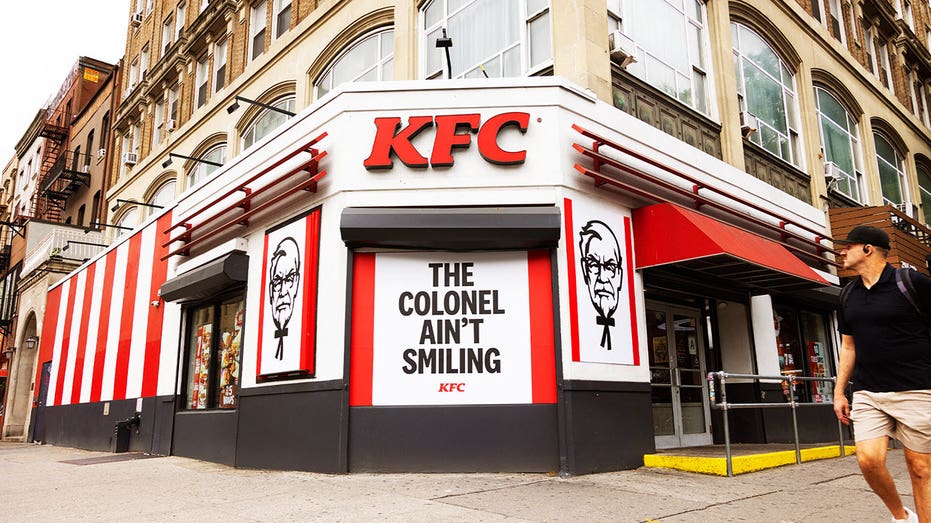 Signage at a KFC with the Colonel looking 'serious'