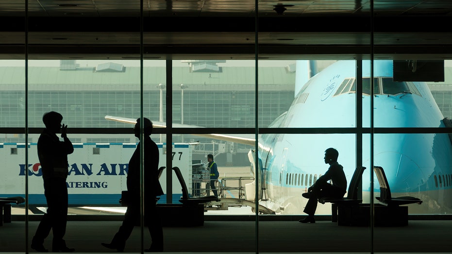 passengers wait at terminal near korean air