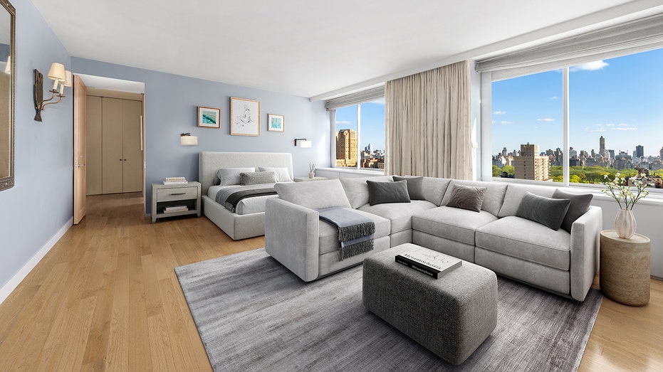 The primary bedroom has views of the city and a spacious seating area.