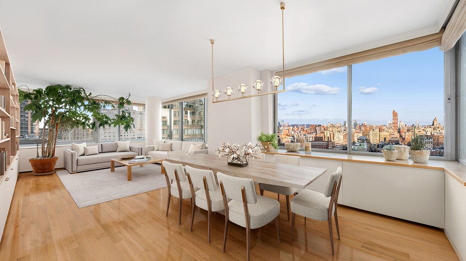 The dining room features a unique light fixture and an additional seating area.