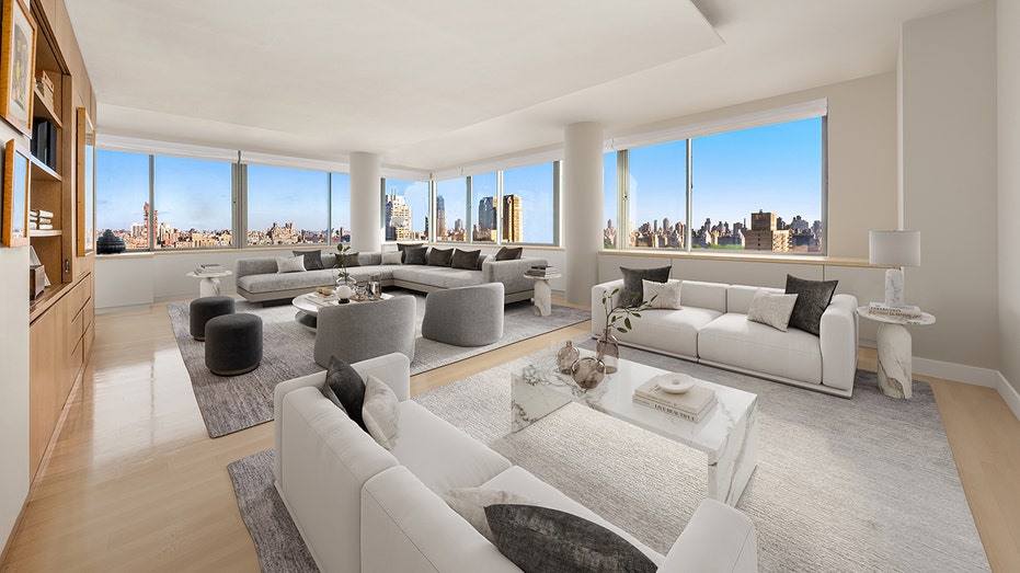 The living room features floor-to-ceiling windows with views of the city.