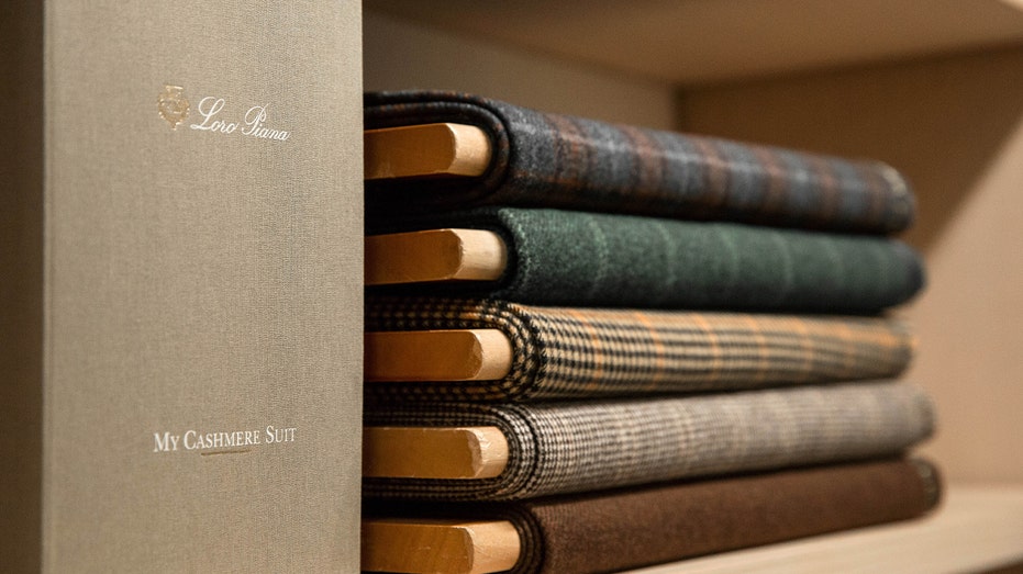 stack of cashmere scarves folded on shelf