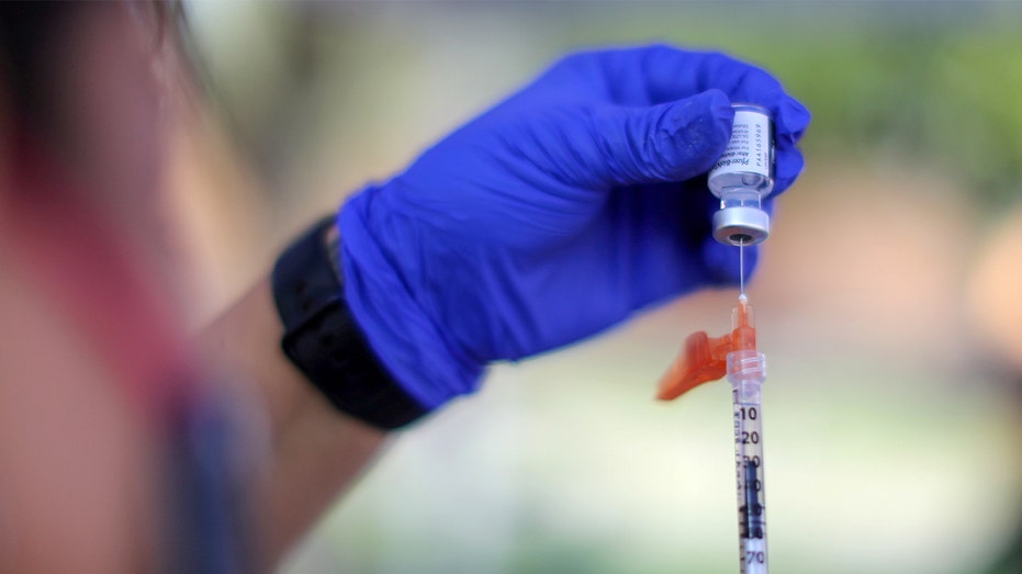 Nurse prepares Pfizer COVID vaccine