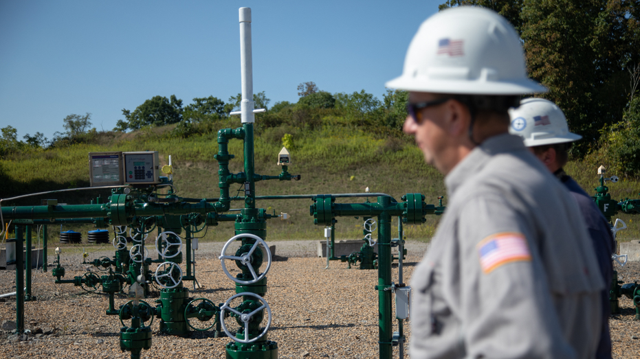 Workers are seen at a natural gas well in Pennsylvania