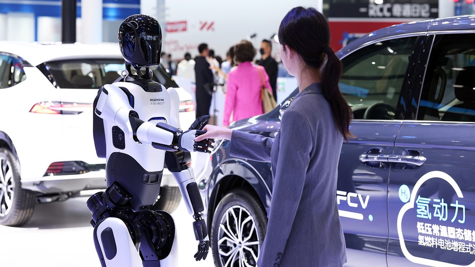 Humanoid robot shakes human's hand