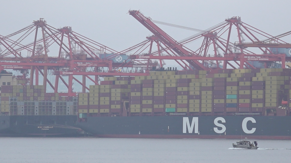 Cargo containers sit on vessels.