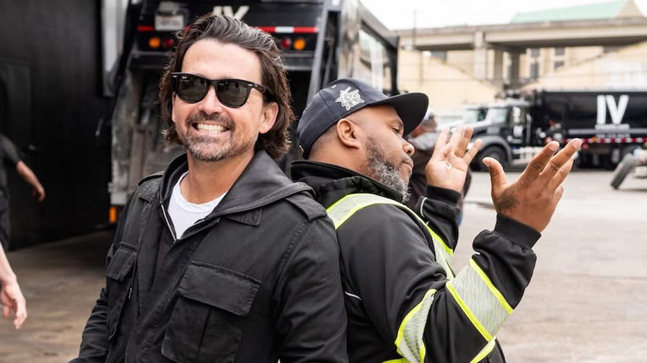 Sidney Torres smiling with IV Waste worker in New Orleans