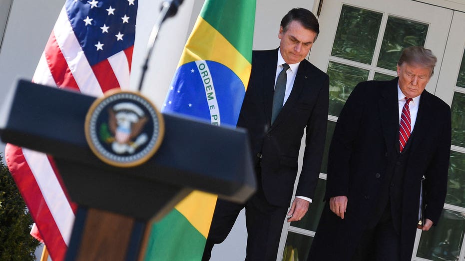 Trump walks with former Brazilian President Bolsonaro during his first term.