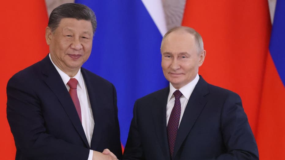 Russian President Vladimir Putin shook hands with Chinese President Xi Jinping