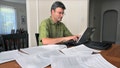 Paul Willen, Boston Federal Reserve economist works with credit reports on the dining room table at his home on Aug. 20, 2010. - Fox News
