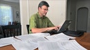 Paul Willen, Boston Federal Reserve economist works with credit reports on the dining room table at his home on Aug. 20, 2010.  - Fox Business News