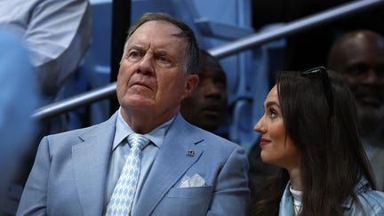North Carolina Tar Heels football head coach Bill Belichick and his girlfriend Jordon Hudson look on during the first half of the game between the North Carolina Tar Heels and the Duke Blue Devils at Dean E. Smith Center on March 08, 2025 in Chapel Hill, North Carolina. - Fox Business News