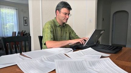 Paul Willen, Boston Federal Reserve economist works with credit reports on the dining room table at his home on Aug. 20, 2010.  - Fox Business News