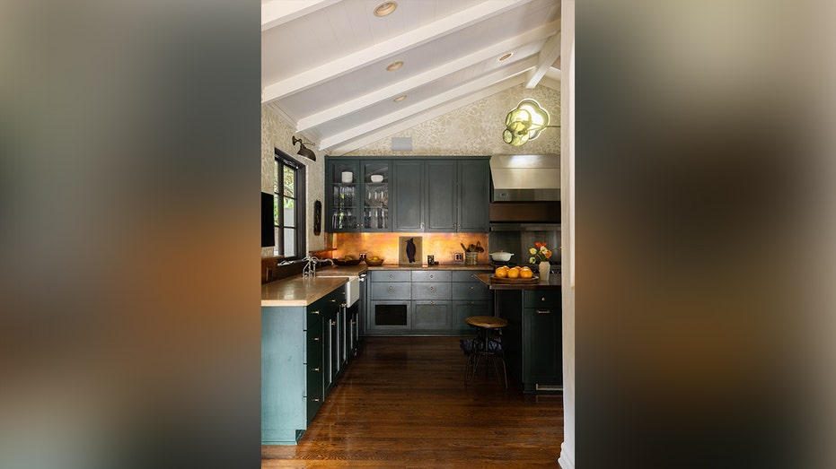 The kitchen features blue cabinets and wooden countertops.