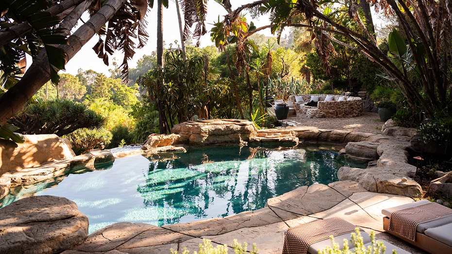 The backyard also features a swimming pool.