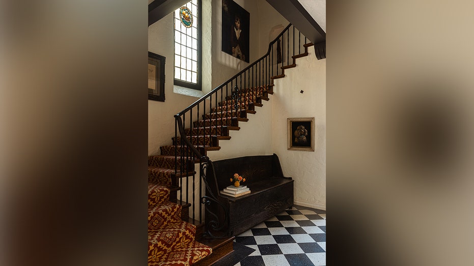 The entryway features a staircase leading to the upper levels.